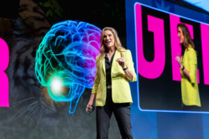 Stress physiologist Dr. Rebecca Heiss explaining the brain's stress response during a keynote