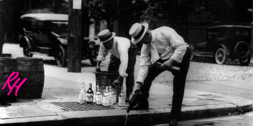 a man pouring alcohol into a manhole