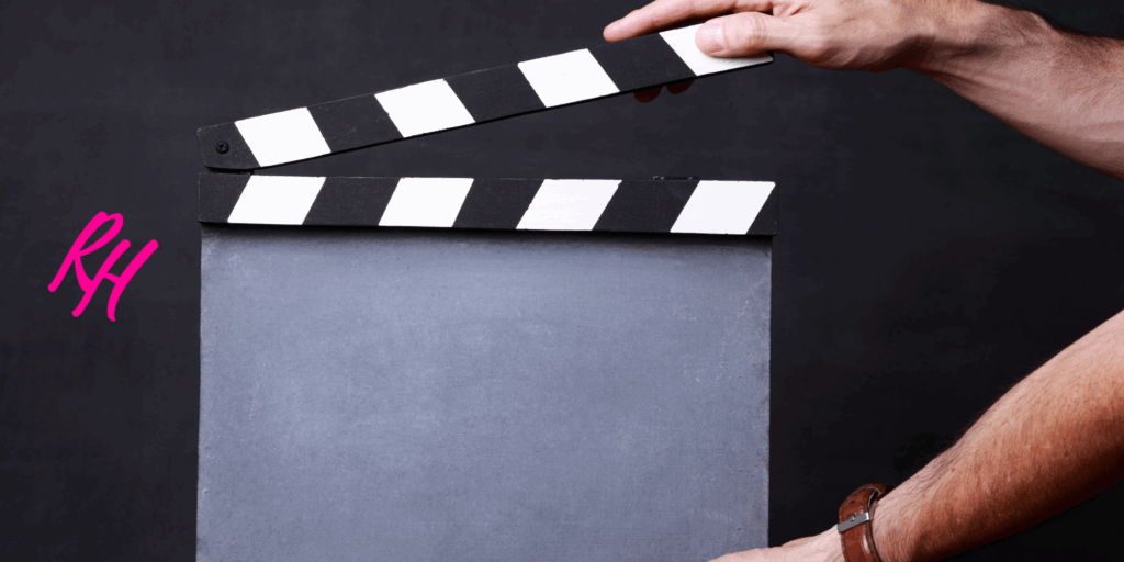 a person holding a clapper board
